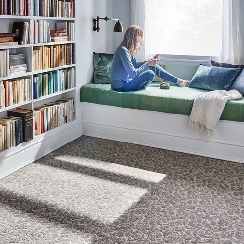 Person reading in the window in a room with gray patterned carpet from 180 Degree Floors in the Nashville, TN area